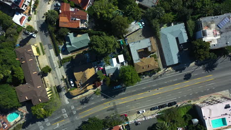 Top-down-drone-shot-over-luxury-homes,-in-sunny-Hollywood-hills,-Los-Angeles