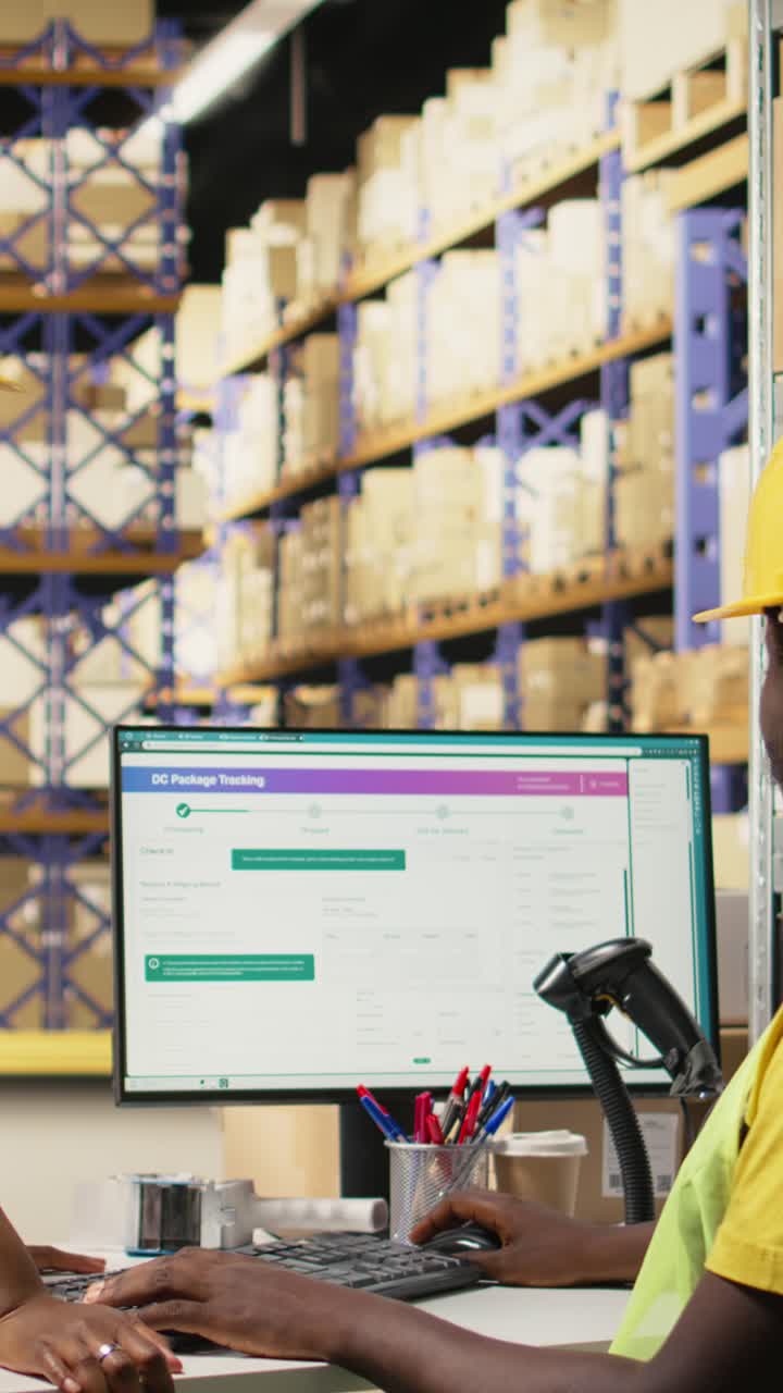 Vertical Video Black staff members sharing happy high five gesture in busy storehouse setting