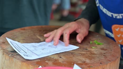 serving a freshly made laab, an isan thai food made of minced meat mixed with onions, chili, mint, salt, lime, and ground rice