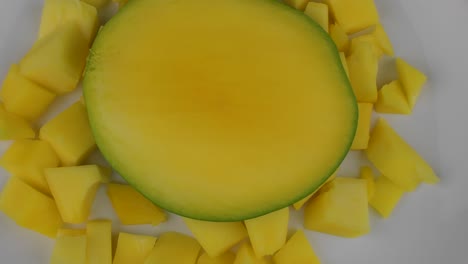 organic tropical fruits, close up slides mangoes on white plate. focus shift and rotate. 4k