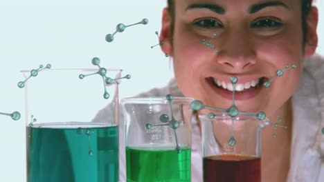 Animation-of-molecules-spinning-over-caucasian-female-scientist-and-laboratory-beakers