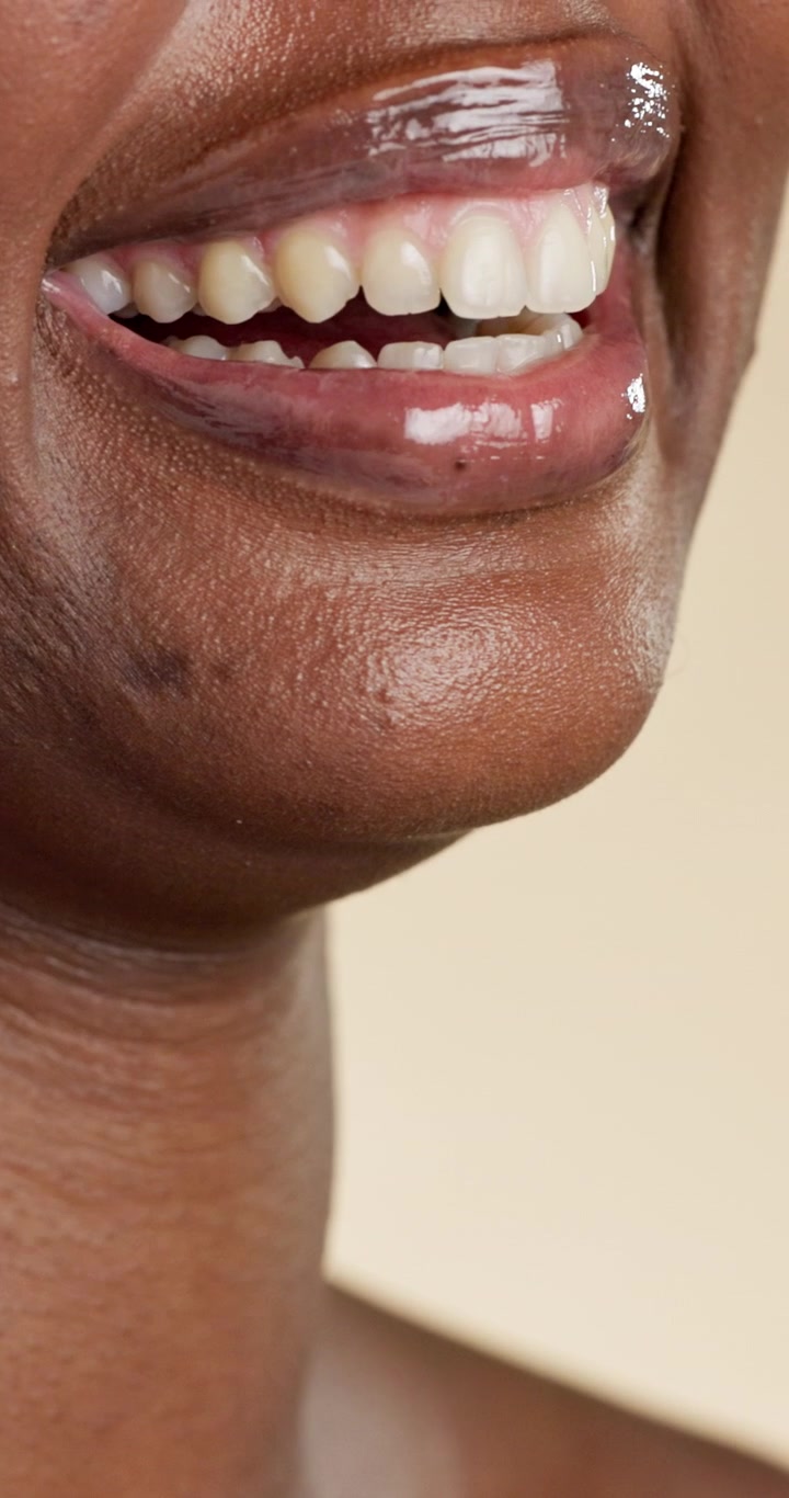 Close-up of a Woman Smiling with Glossy Lips