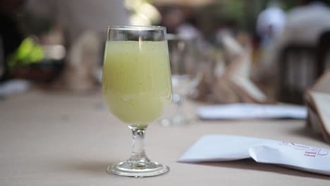 close-up bokeh shot of a freshly poured drink in a glass on a table