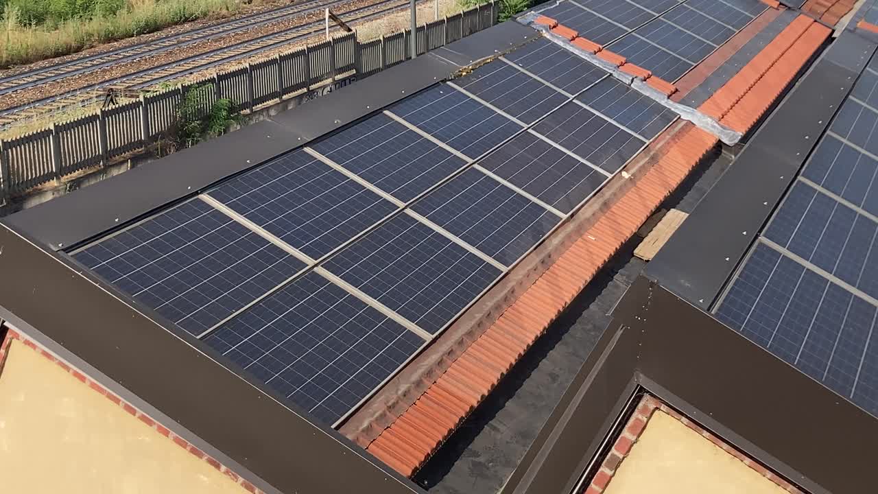 Detailed view of solar panels on a Milan rooftop. Close-up of surfaces and textures, representing innovation, clean energy, and urban technology.