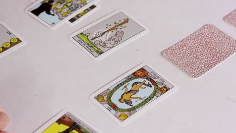 hand flipping tarot cards of celtic cross spread, panning shot