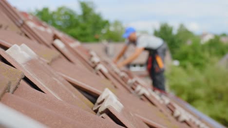 Blurred-technician-solar-panel-installation,-focus-on-roof-tiles,-static