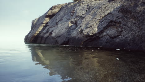 serene seascape: clear water reflecting rocky cliffs