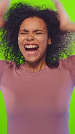 young crazy anxious african american woman covers ears and screams loudly