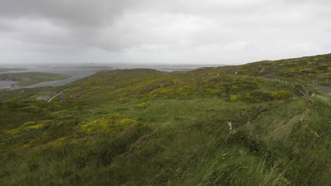 panning shot from the sky road in county galway, ireland looking at atlantic ocean and the coast of ireland in 4k