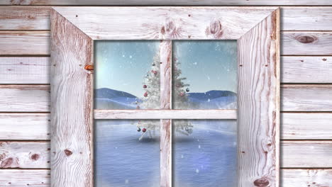 Wooden window frame against snow falling over christmas tree on winter landscape