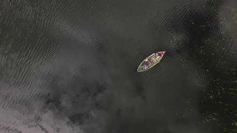 fisherman in the boat wide view from above aerial