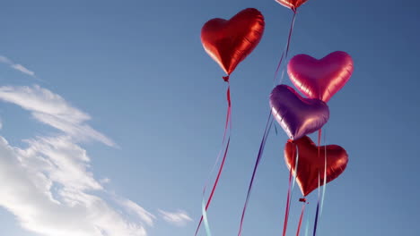 Colorful Heart Balloons Floating in a Blue Sky