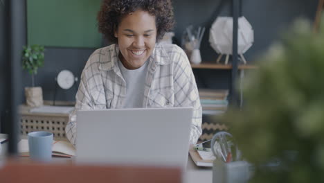 young woman working on laptop at home