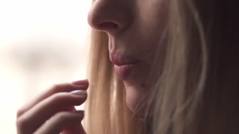 woman eating juicy slice of pomelo, close up portrait