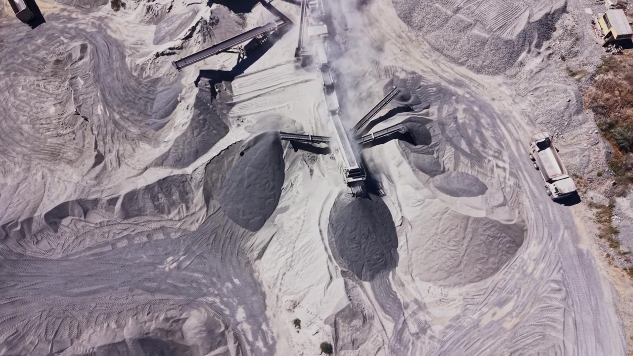 Heavy machinery working in a gravel pit during daylight hours