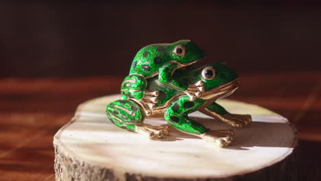 decorative frogs on a presentation base