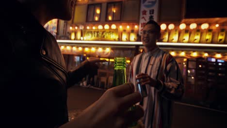 friends enjoying drinks at a bar at night