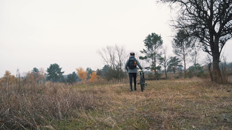 Athlete Man Walking With A Mountain Bike In The Countryside