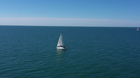 Flying-around-a-sailing-boat-in-the-mediterranean-sea-sunny-day-blue-sky-France