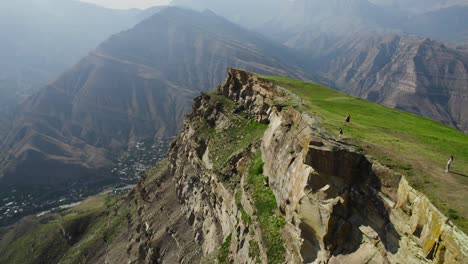 mountain cliff top with hikers