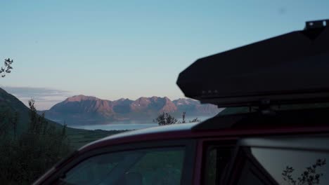 sports utility vehicle with roof tent in serene nature background