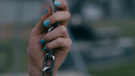 close-up-hands-lonely-woman-on-swing-in-playground-park-swinging-alone-teenage-depression-concept