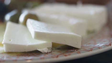 close-up of feta cheese slices on a plate