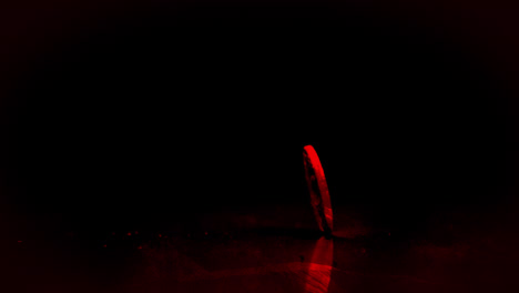 Coin-spinning-with-red-light-on-black-background