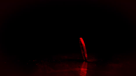 coin spinning with red light on black background