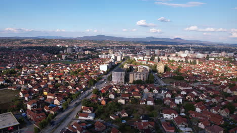 aerial view of cacak city, serbia. buildings and street traffic on sunny summer day