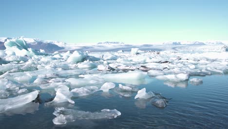 frozen sea lagoon in iceland with ice floes and snow, bright sky