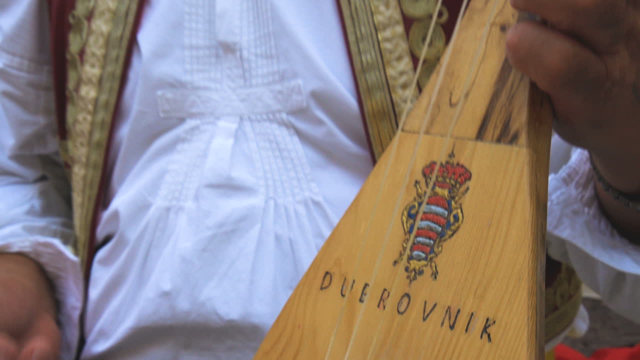 Man Plays Croatian Musical Instrument in Dubrovnik
