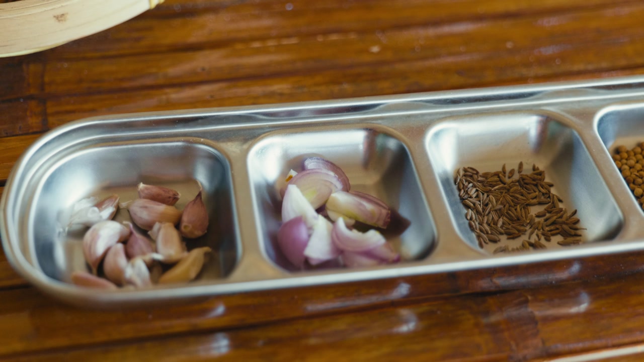 Seasoning ingredients prepared for making Thai chili paste, featuring fresh herbs and spices ready for traditional Thai cooking.