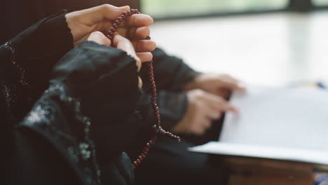 Portrait-of-an-Asian-Muslim-women-in-a-daily-prayer-at-home-reciting-Surah-al-Fatiha-passage-of-the-Qur'an-in-a-single-act-of-Sujud-called-a-Sajdah-or-prostration