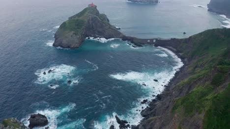 Rippled-ocean-near-green-mountain-with-walkway-under-sky