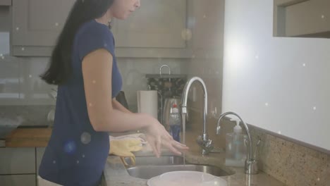 animation of bubbles falling over woman  washing her hands at home