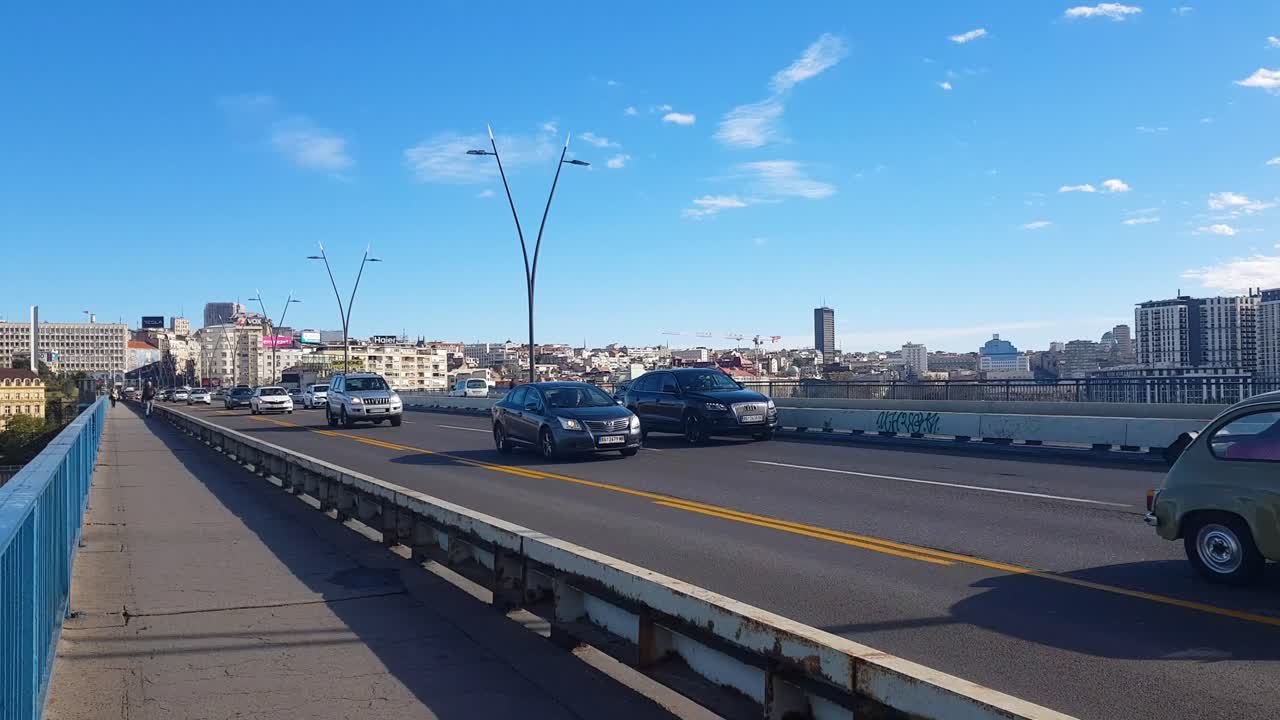 Busy but flowing car traffic on Brankov bridge crossing Sava river on a sunny morning in Belgrad Serbia