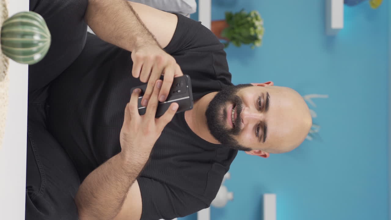 Vertical video of Man getting breakup texting gets upset.