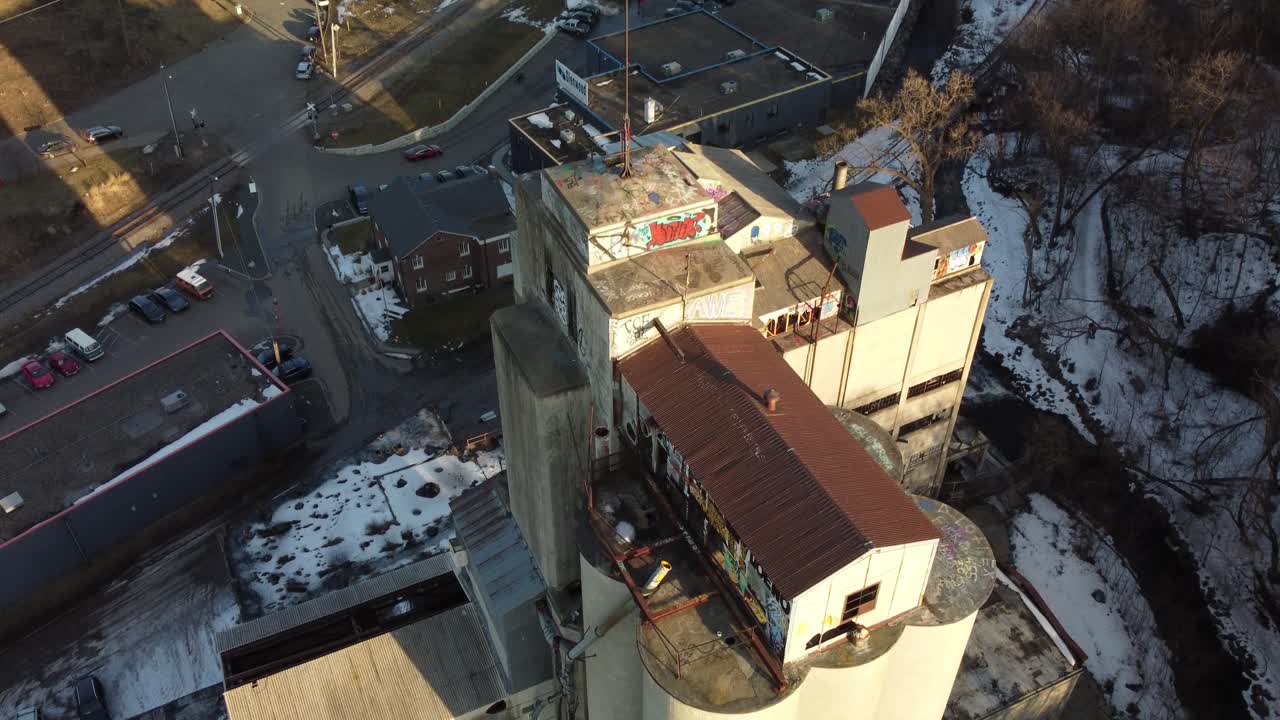 Drone descending on abandoned grain elevator revealing downtown Minneapolis