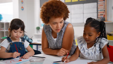 female teacher with multi-cultural elementary school pupils in art class