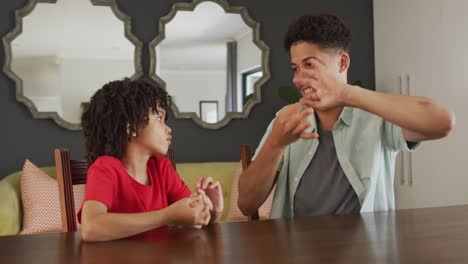 Happy-biracial-man-and-his-son-using-sign-language