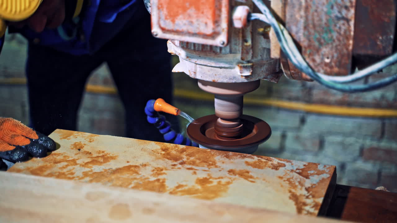 Worker cutting stone block. Industrial worker making horizontal cut with electric saw during align marble tiles