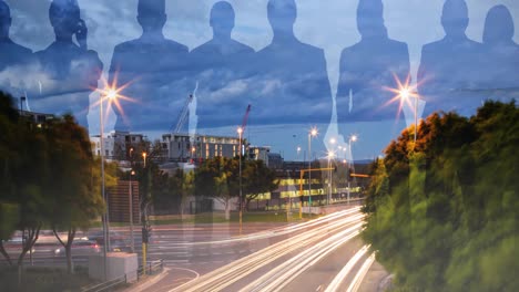 Animation-of-people's-blue-silhouettes-over-cityscape-in-evening