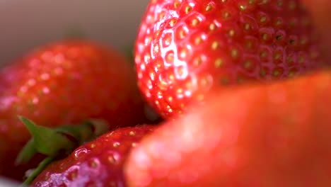 macro panning of strawberries in a bowl