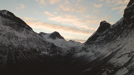 bright sky and snowy mountain peak in geiranger norway - aerial shot