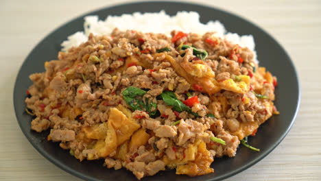 stir-fried minced pork with basil and egg topped on rice - asian food style