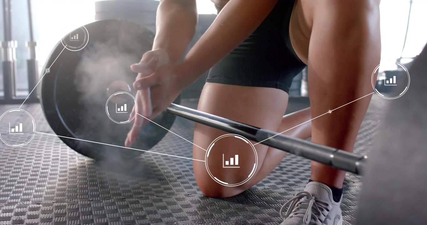 Woman kneeling on gym mat rubbing chalk activating performance data overlays on barbell for fitness