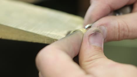 close ups of a craftsman making jewellery in a workshop