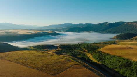 aerial view of a foggy valley and rolling hills