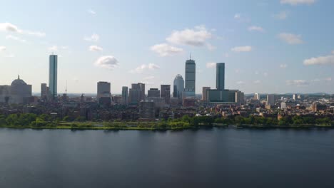 cinematic aerial shot above charles river, boston's back bay in background